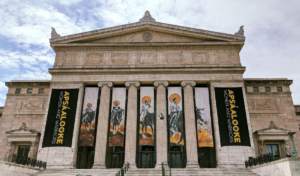 “Sacred Under the Cliffs of the Yellowstone,” honoring heroic Crow women, is part of Pease’s Madonna series and displayed in banners for “Apsáalooke Women and Warriors” at the Field Museum.
