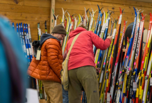 Customers at the Ski Swap check out a rack of skis