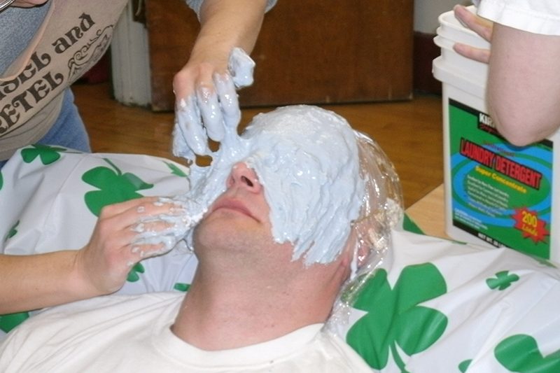 A layer of alginate is spread over Scott's face.