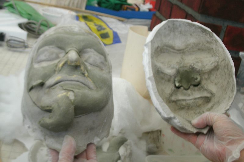 Clay is used to build up Shrek's features on the mold of Scott's face.