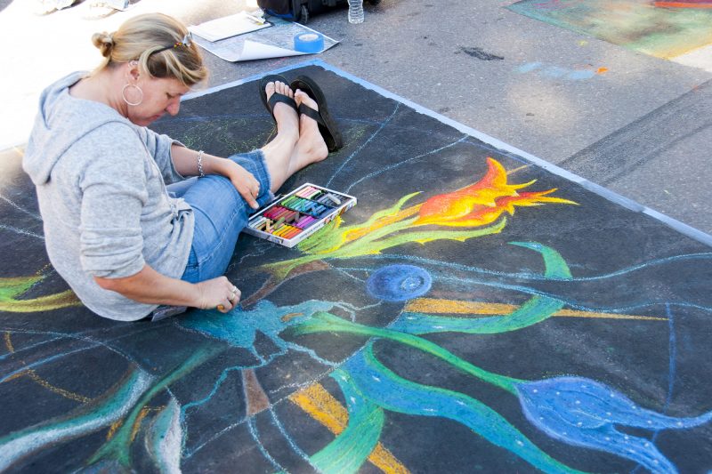 Artist Holly Schineller at work on the street.
