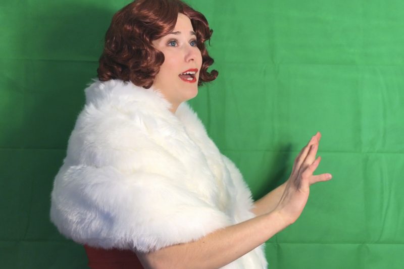Actress rehearses her role in Young Frankenstein against a green screen.