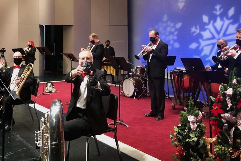 The Holiday Brass Quintet prepares for festive concert. 