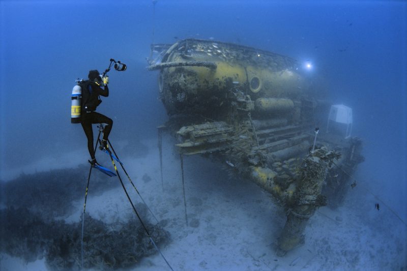 Brian Skerry sits atop a 20-foot-high underwater tripod to photograph the Aquarius Habitat off Key Largo, Florida. Skerry lived inside this habitat for seven days.