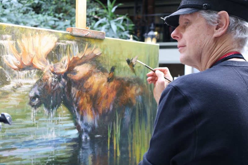 Robert Krogle pust finishing touches on a moose at the Out West Art Show. 
