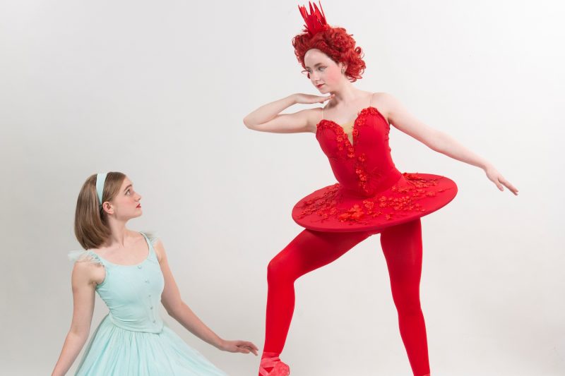 Alice (Elinor Goehring) encounters the Queen of Hearts (Kaitlyn Ruch) in Queen City Ballet's Alice in Wonderland. 