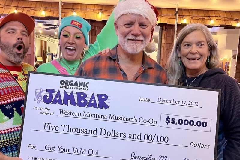 Wade Holland and Abby, Doug and Andrea Ruhman celebrate JAMBAR's recent donation to the Western Montana Musicians' Co-op in Ronan.