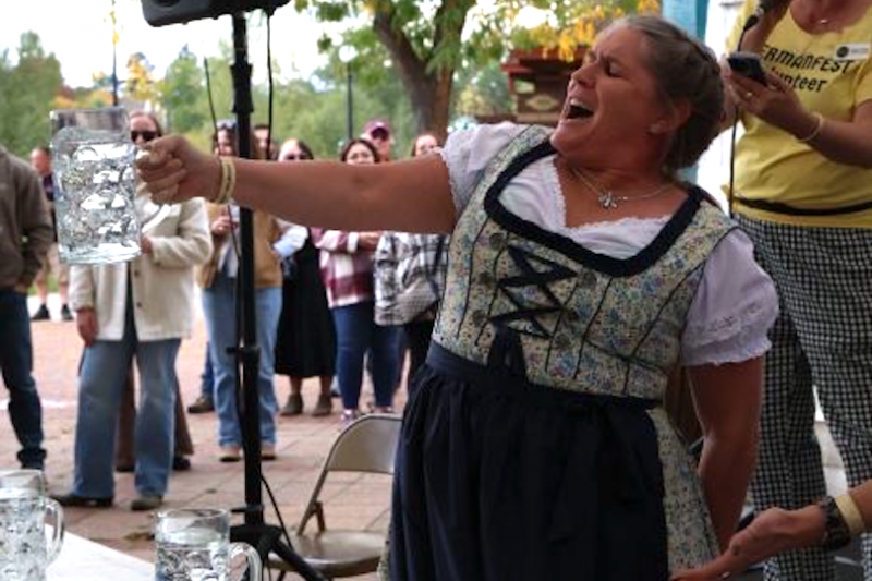 photo of woman h olding a beer stein